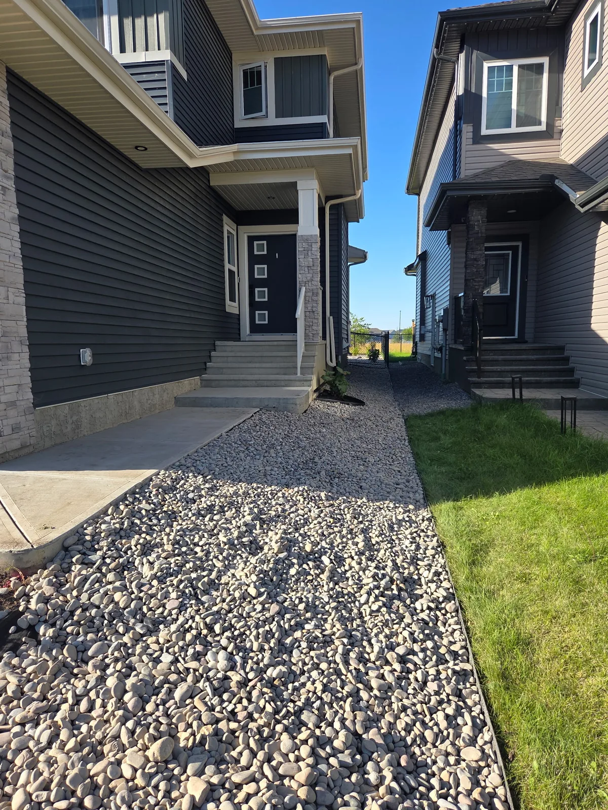 Decorative rock pathway connecting the front entry and side yard