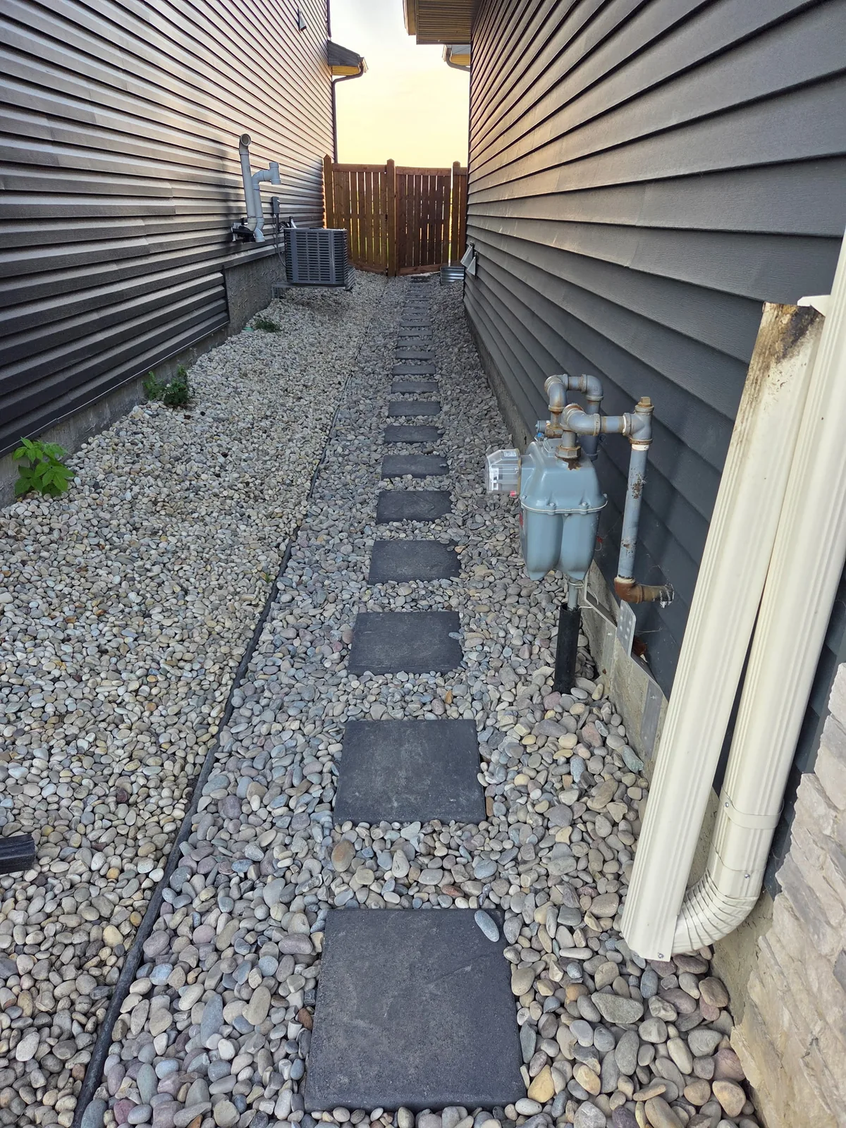 Finished side-yard stepping-stone path set in decorative rock