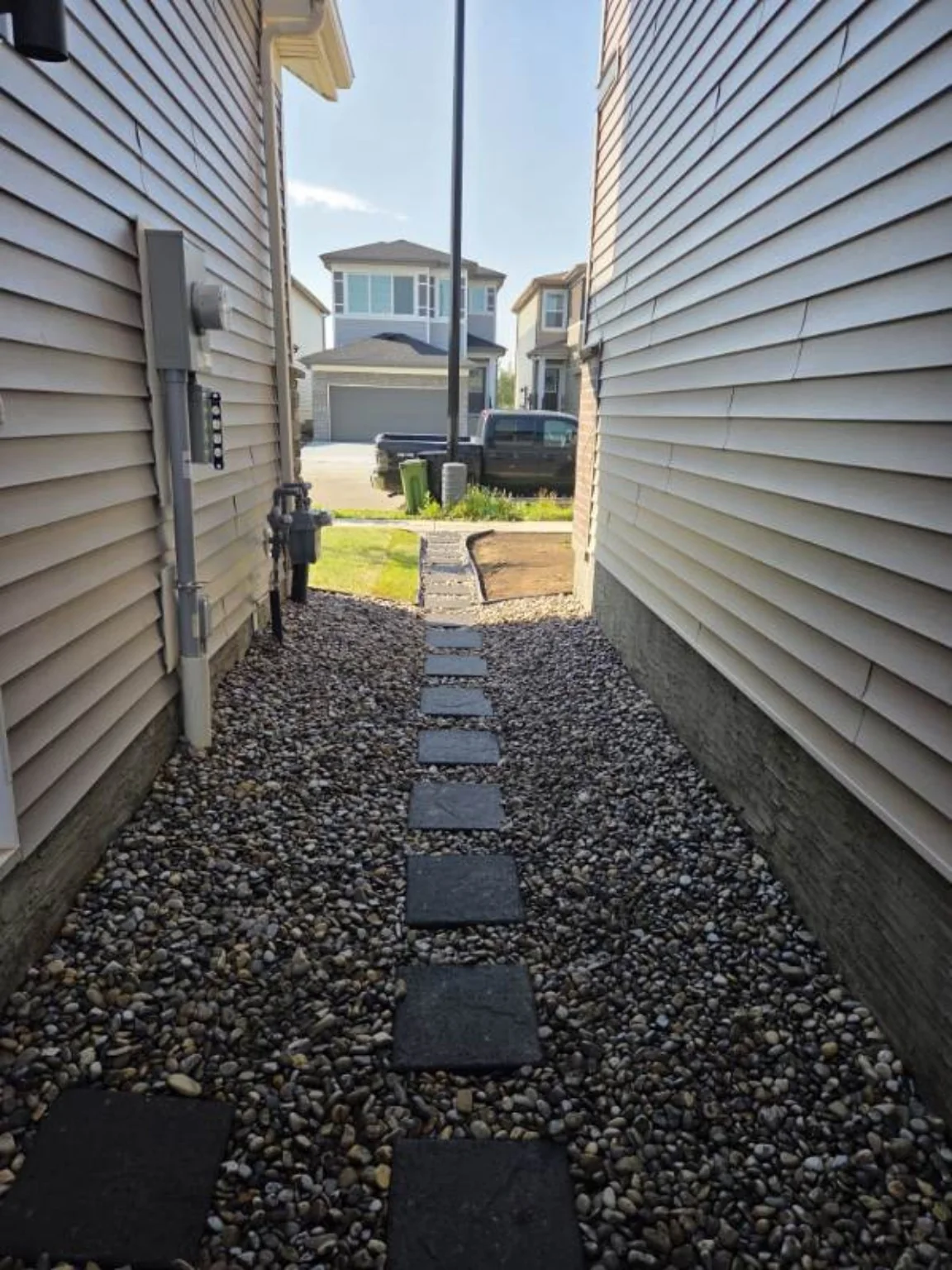 Finished side yard with river rock and stepping stones