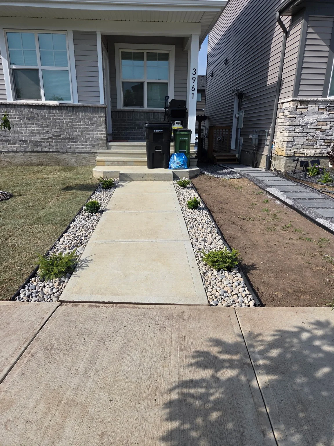 Finished walkway with decorative rock and shrubs